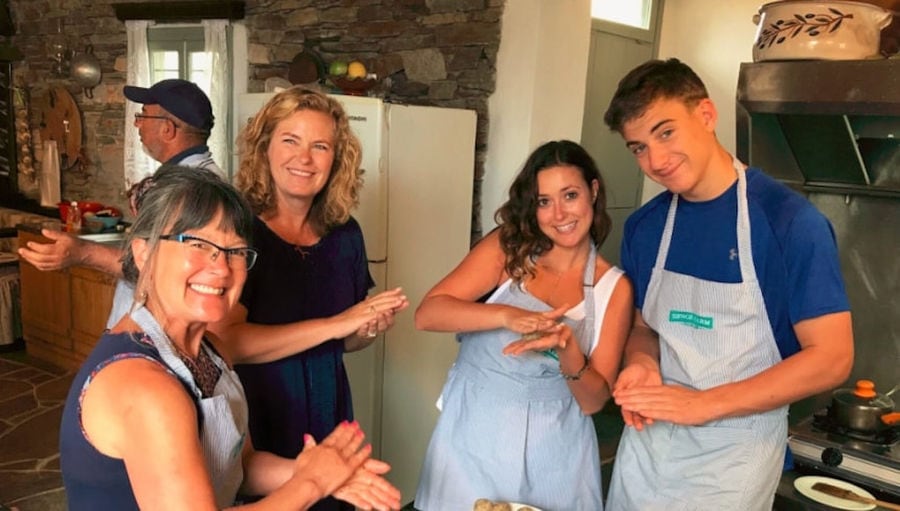 tourits dressed with aprons and smiling happily at the camera at 'Narlis Farm' and cooking meet balls
